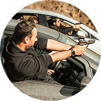 Tactical Training. Picture of trained specialists aimind handguns out of car windows.