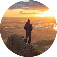 Wilderness Survival. Picture of a man observing a sunset in the wilderness.
